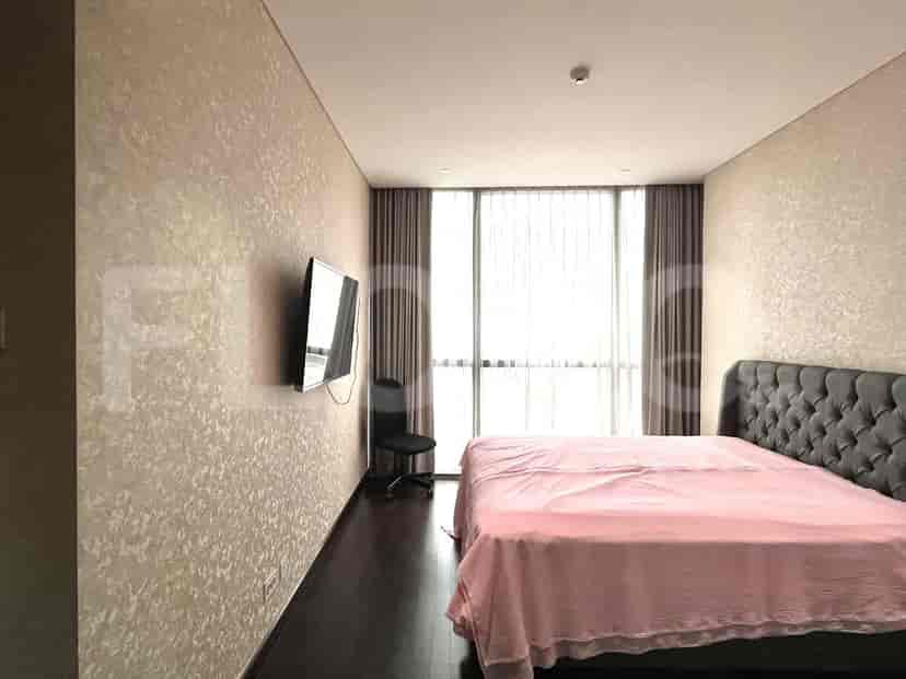 Bedroom with a king-sized bed, smart TV, and large window.