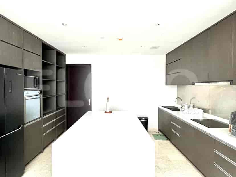 Modern kitchen with ample storage and a white countertop.