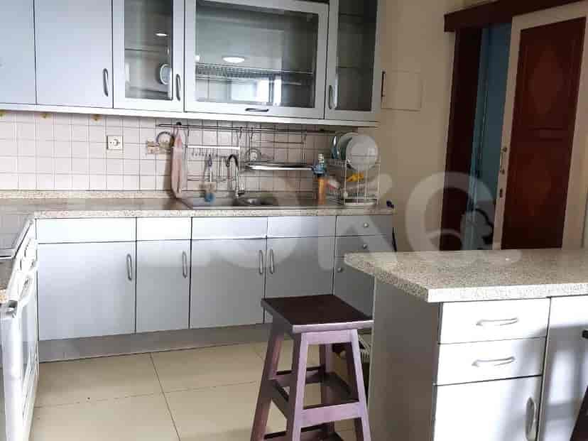 A fully equipped kitchen with cabinetry, a stove, and a counter.