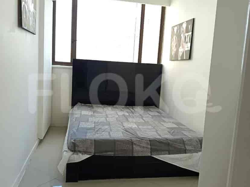 Compact bedroom with a double bed and artwork on the wall.
