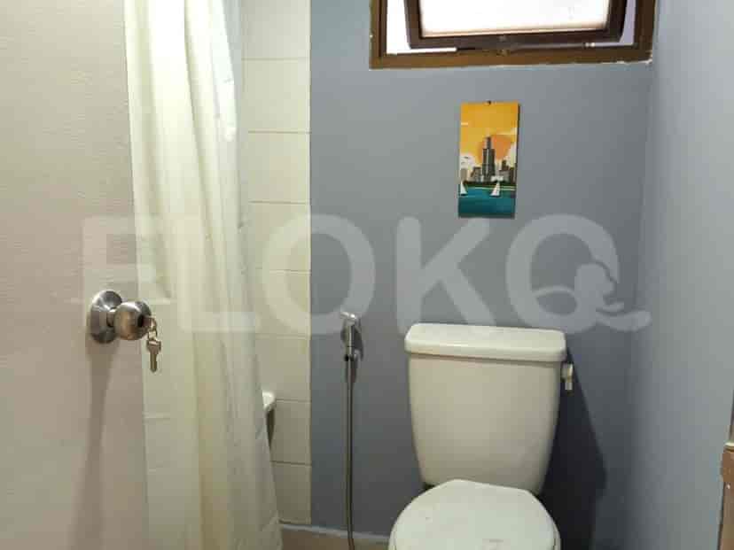 Small bathroom with a toilet and shower curtain.