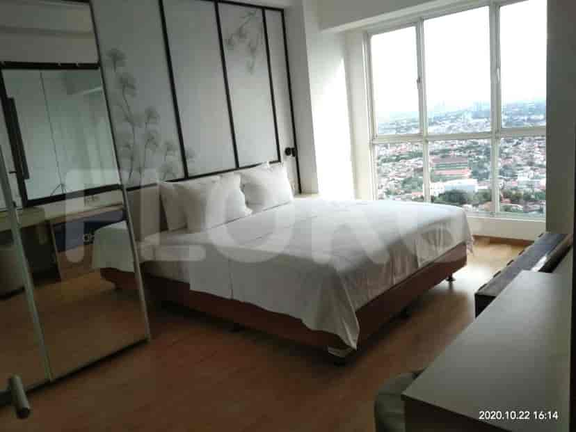 Bedroom featuring a large bed and decorative wall panels.