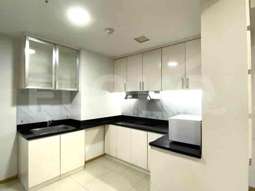 Modern kitchen with white cabinets and black countertops.