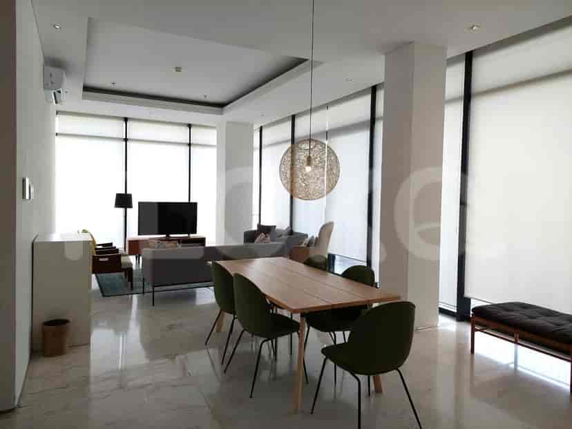Open-plan living and dining areas with a dining table, chairs, and a view of the living space.