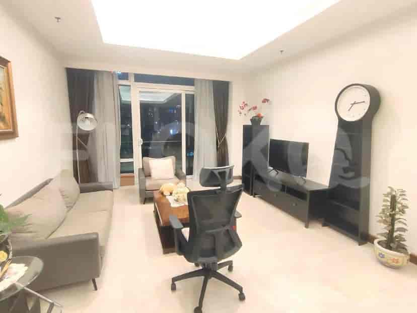 Living room with sofa, TV, and large window.