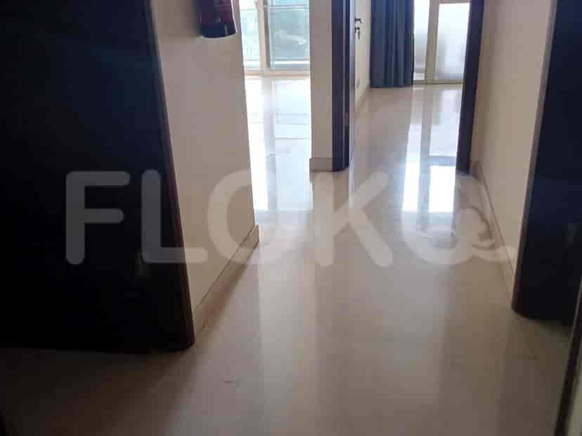 View of a room with polished floor and window.