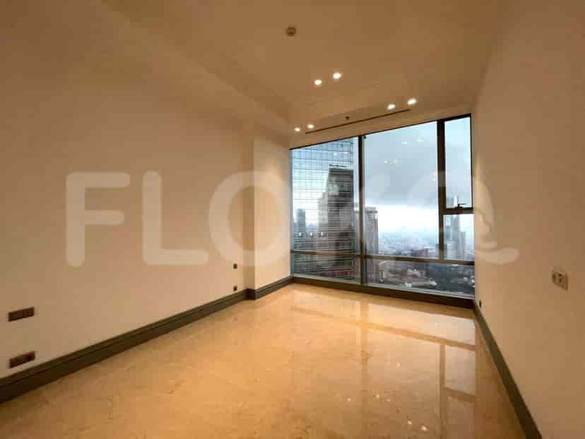 A bedroom with large windows offering a city view and marble flooring.
