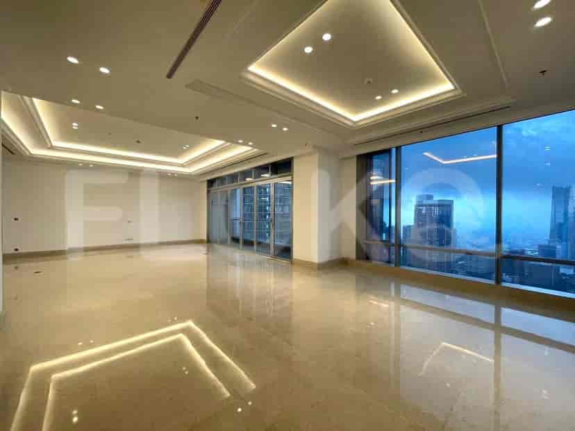 A spacious, modern living area with marble flooring, large windows, and recessed lighting.
