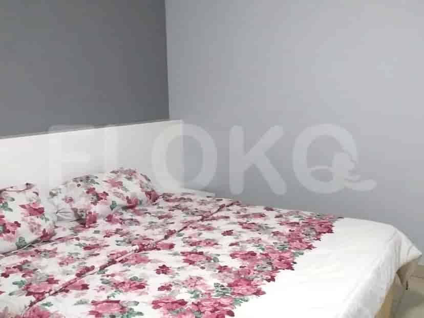 Bedroom with a double bed and floral bedspread.