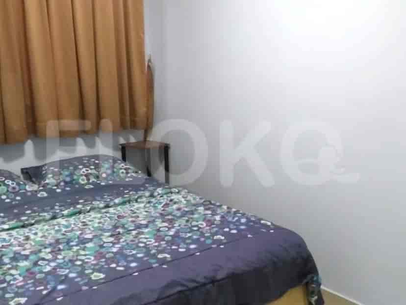 Bedroom with a double bed and curtains.