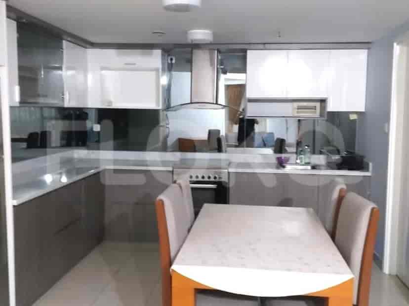 Modern kitchen with cabinets and dining table.