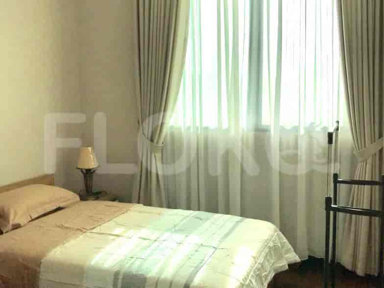 Bedroom with a bed and curtains.