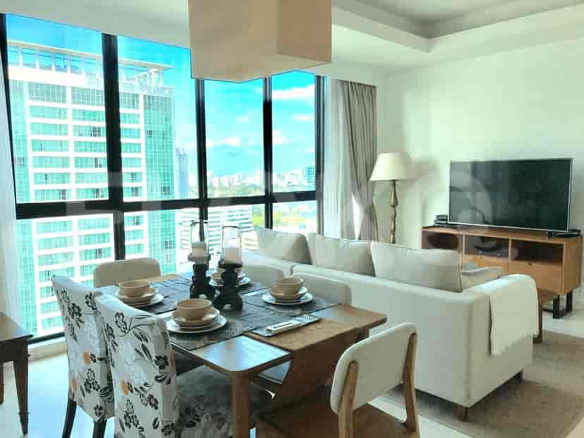 Living room with dining area, featuring a large window, and a modern aesthetic.