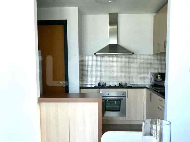 Modern kitchen with wooden cabinets and stainless steel appliances.