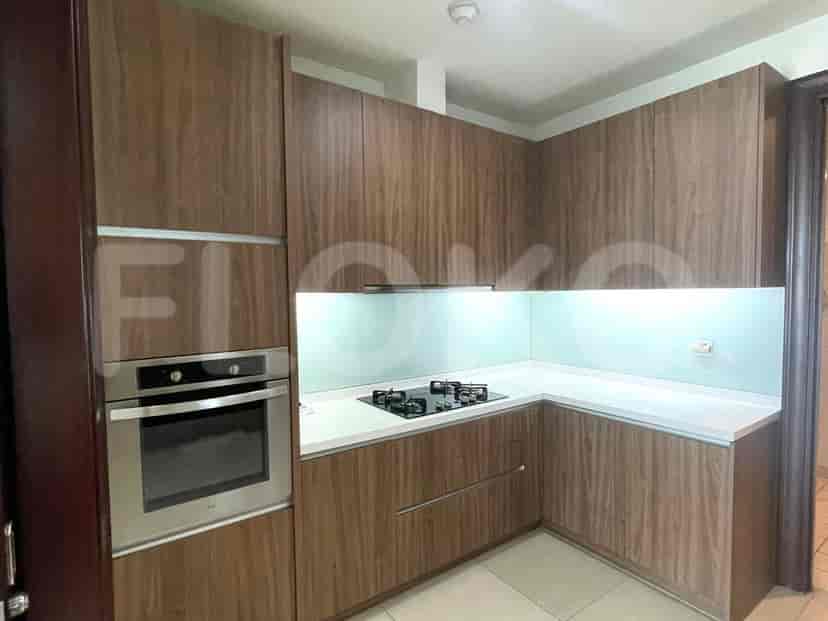 A modern kitchen with wooden cabinets and built-in appliances.