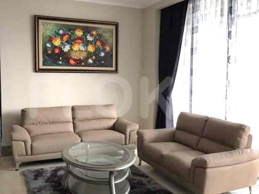 A cozy living room with a two sofas, coffee table and art piece.