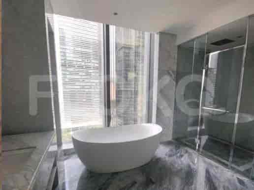 A luxurious bathroom with a bathtub, shower, and large windows.