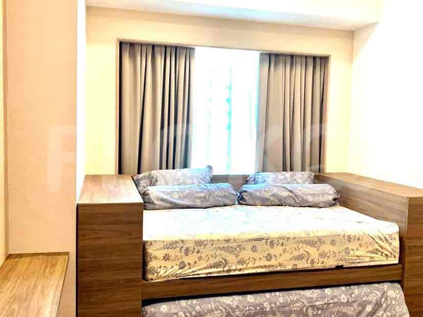 A cozy bedroom with a built-in bed, neutral curtains, and a simple design.