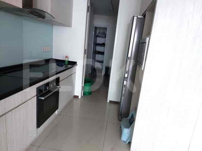 Modern kitchen with built-in appliances and a narrow hallway.