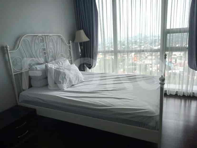 Bedroom with a white bed frame and city view.