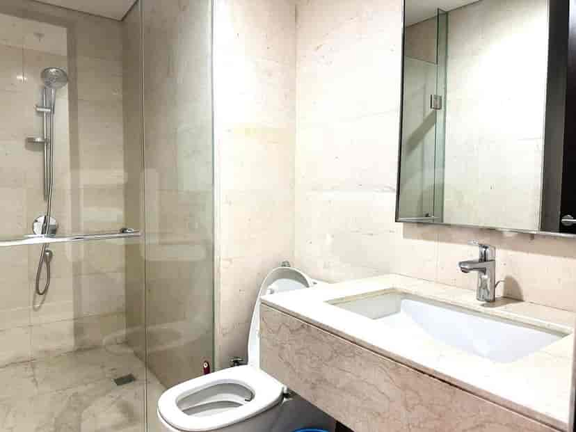 Bathroom with a walk-in shower, vanity, and toilet.