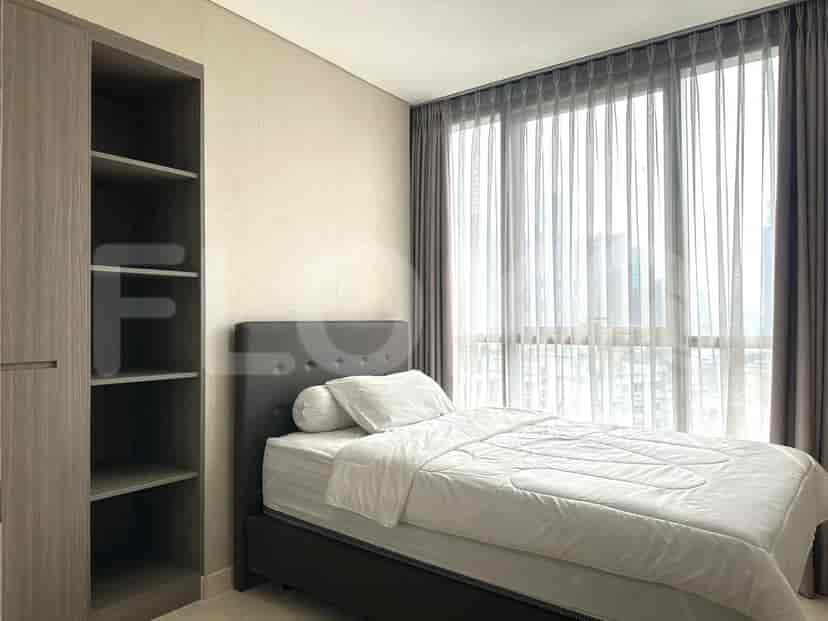 A bedroom with a double bed, wardrobe, and window.