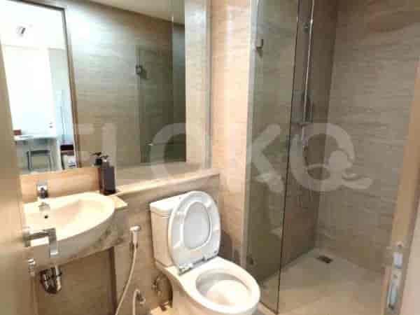 A modern bathroom with a sink, toilet, and a shower.