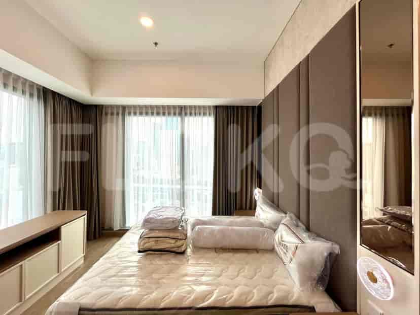 A well-lit bedroom featuring a king-sized bed, curtains, and a modern aesthetic.