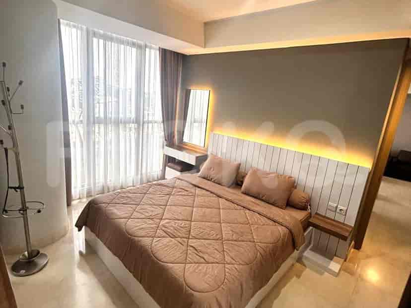 Bedroom showing the bed and a large window.