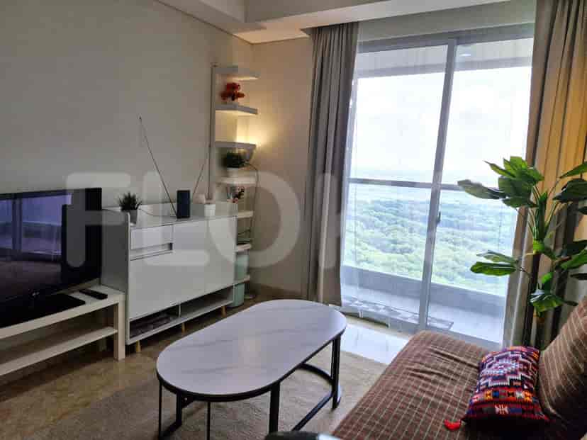 A living room with a white cabinet, sofa, oval table, and a view through a large window.
