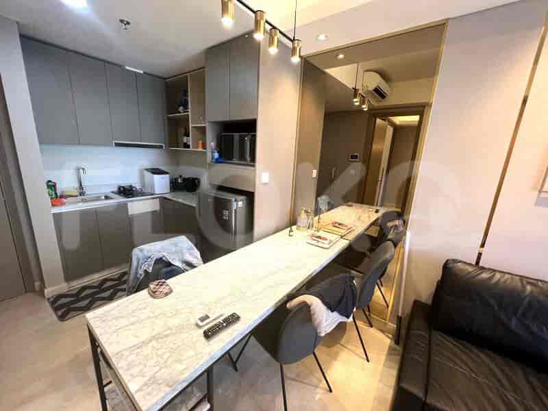 A fully equipped kitchen with a dining table offering a place to dine.