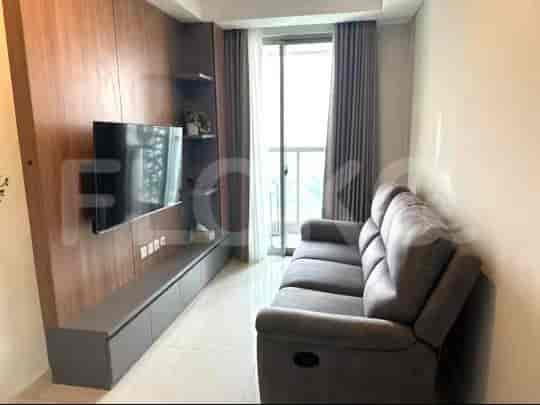 Modern living room with TV, sofa, and window.