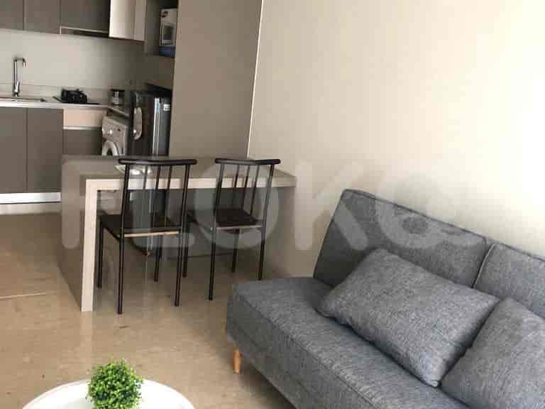 Modern kitchen with dining table and chairs, featuring built-in appliances.