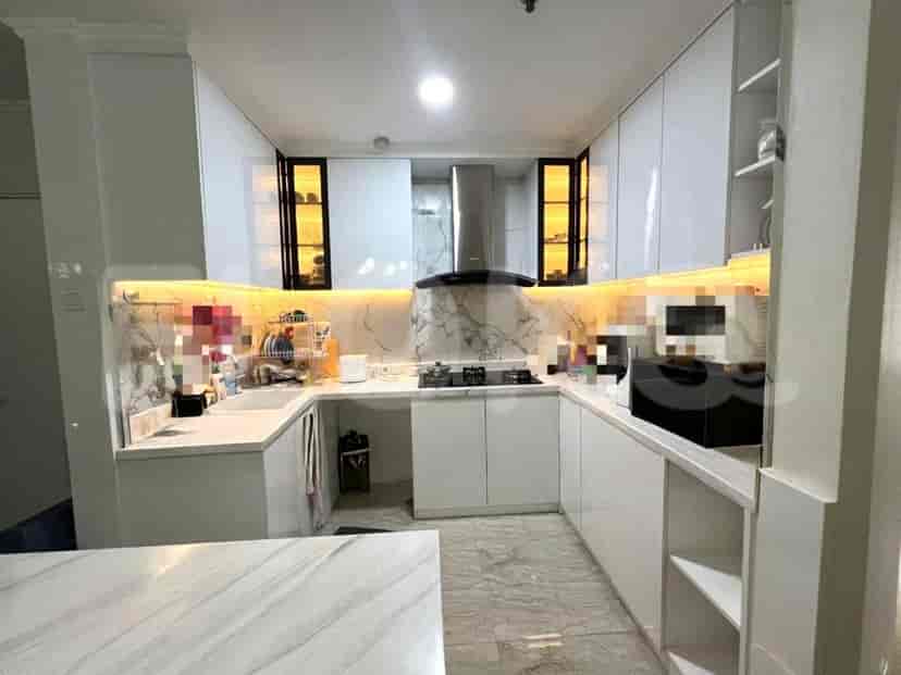 A modern white kitchen with cabinets and appliances.