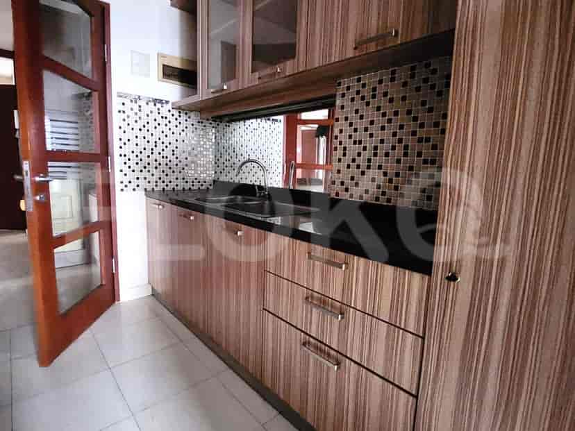 A kitchen with wooden cabinets and a black countertop.