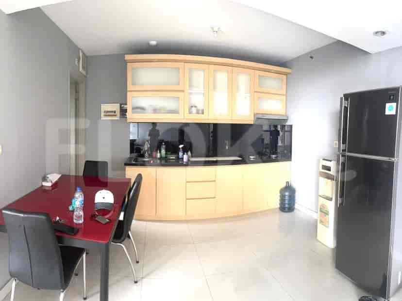 A kitchen with a dining area, cabinets, and appliances.