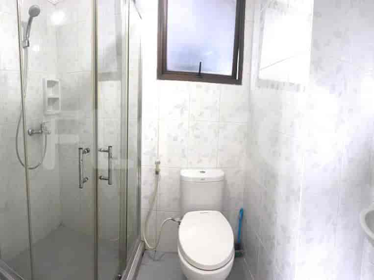 A bathroom with a shower and toilet.
