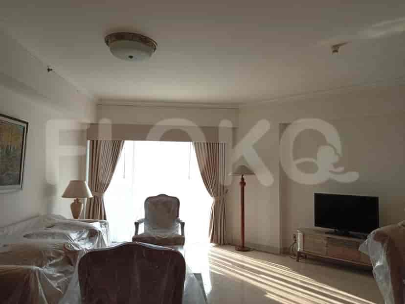 Living room featuring curtained window and a TV area.