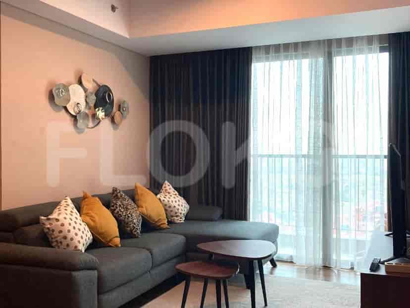 A modern living room with a grey L-shaped sofa, patterned cushions, and a coffee table.