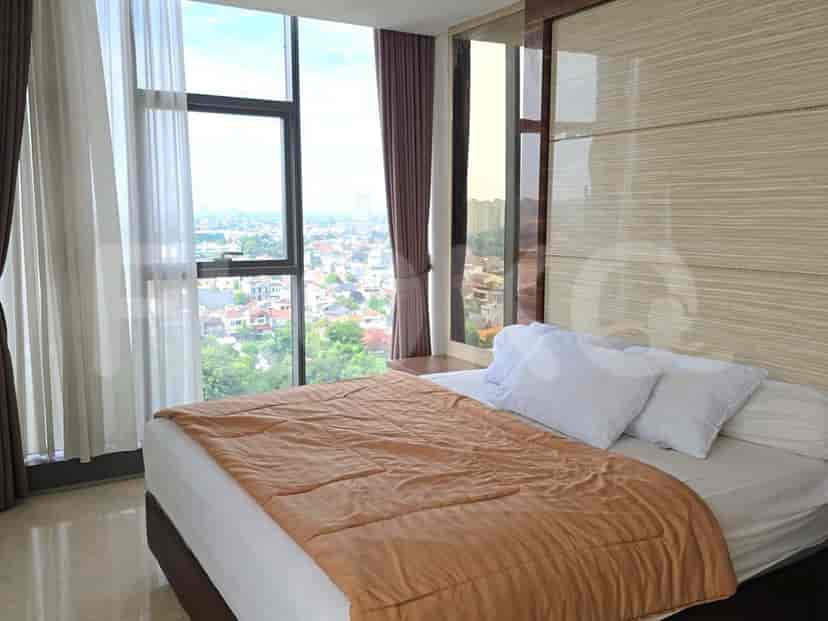 Cozy bedroom with a large bed and city view.