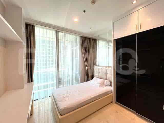 A second bedroom with a single bed, window, and closet.