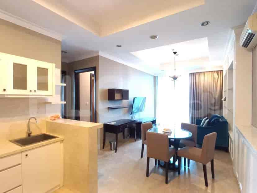 A combined living space and kitchenette, featuring a dining area and a compact kitchen setup.