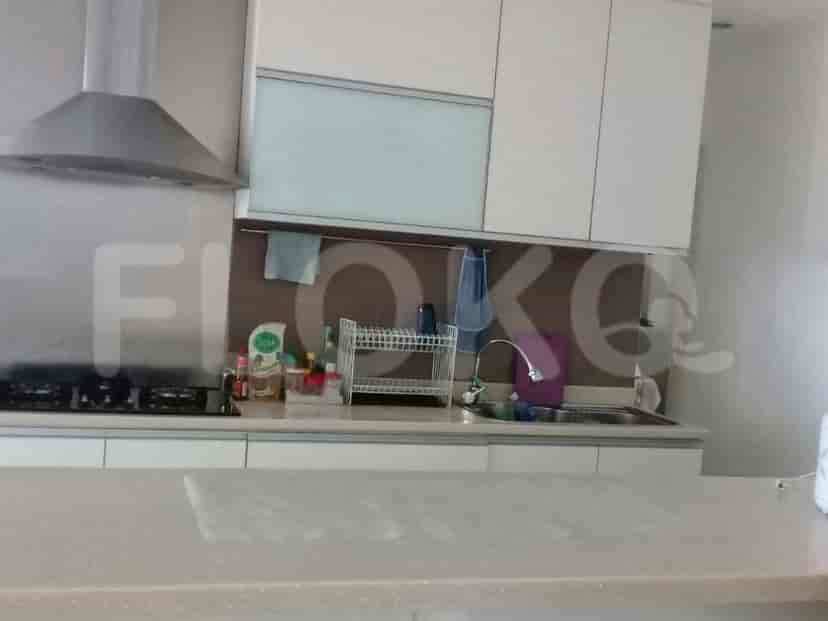 A modern kitchen with white cabinets and a stainless steel range hood.