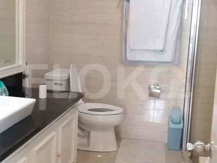A bathroom with a toilet, sink, and shower.