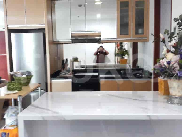 Modern kitchen with stainless steel appliances and a marble island.