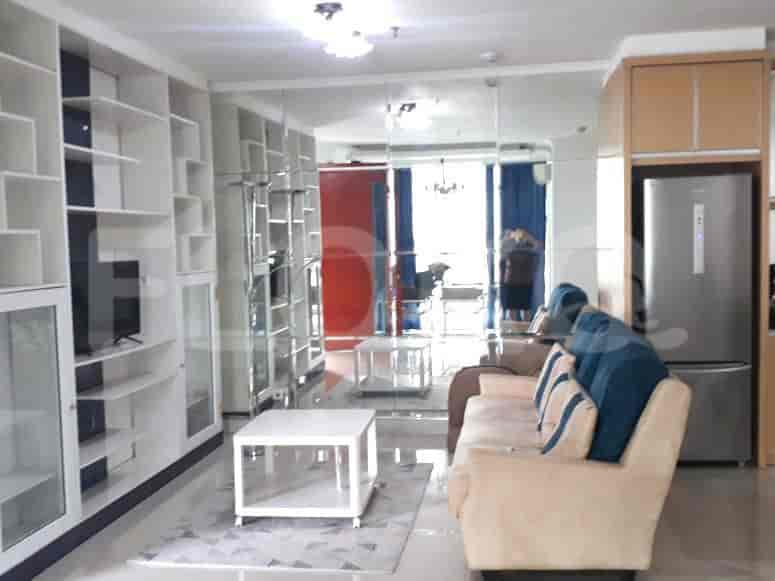 Spacious living room with large mirror, sofa, and built-in shelving.