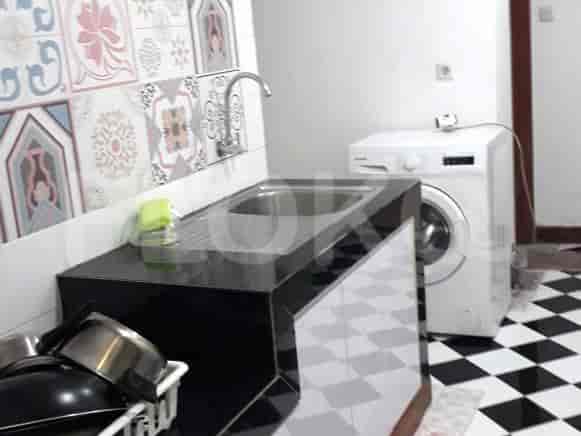 Close-up of a sink area with a washing machine.