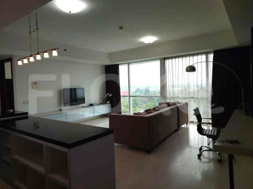 Spacious living area with a grey sofa, TV, and large window.