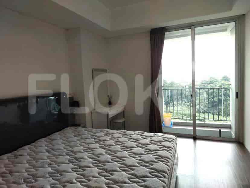 Bedroom with a bed, dressing table, and access to a balcony.
