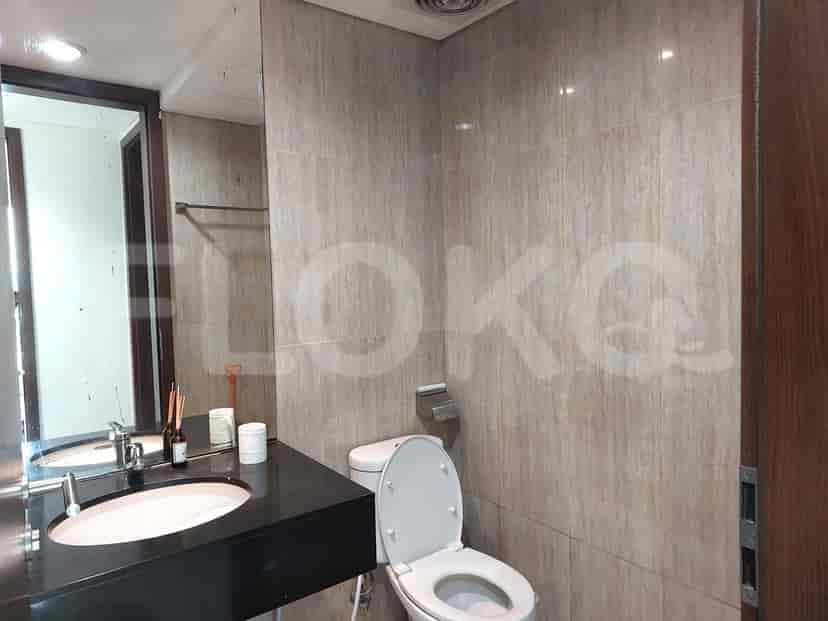 Modern bathroom with toilet and sink.